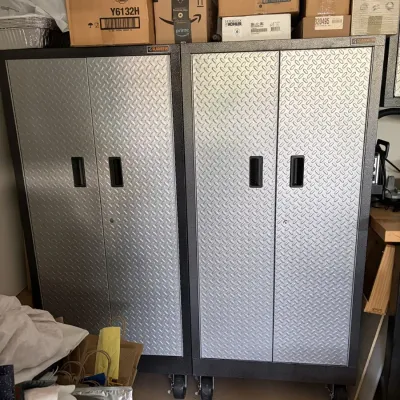 Pair of Gladiator modern rolling steel garage storage cabinets with diamond plate double doors.