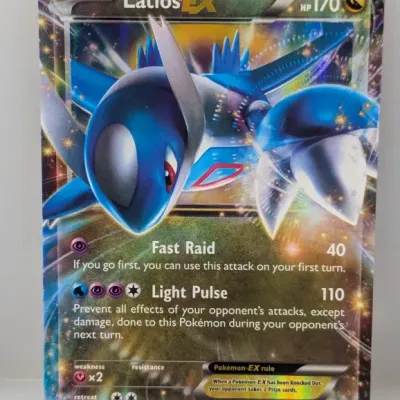 Latios EX black star promo Pokémon trading card, numbered XY72, featuring full-art holographic illustration by Ayaka Yoshida.