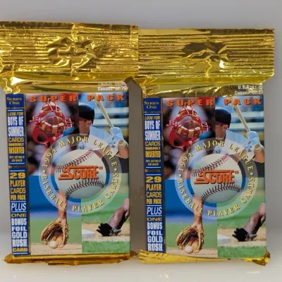Two sealed packs of 1994 Score Series One Major League Baseball Super Packs in gold foil packaging.