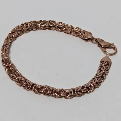 Rose gold Byzantine chain bracelet with a lobster claw clasp.