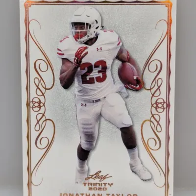 2020 Leaf Trinity Jonathan Taylor rookie football card, featuring the Wisconsin Badgers running back in a white uniform.