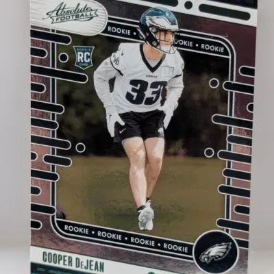 Panini Absolute Football rookie card featuring Cooper DeJean of the Philadelphia Eagles in a white jersey.