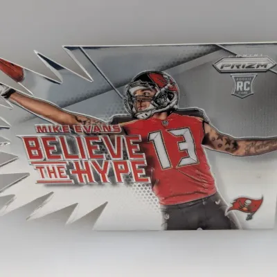 2014 Panini Prizm 'Believe The Hype' die-cut rookie card featuring Mike Evans of the Tampa Bay Buccaneers.