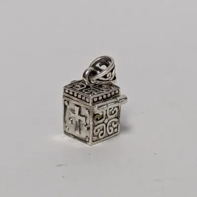 Sterling silver prayer box charm or pendant, featuring intricate filigree work and a cross motif.