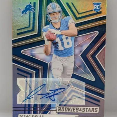 Panini Rookies & Stars Isaac TeSlaa autographed rookie card featuring the Detroit Lions wide receiver, displaying a holographic star...