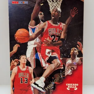 Vintage NBA Hoops Michael Jordan basketball trading card featuring an action shot of Jordan driving toward the basket in his Chicago...