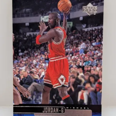 1990s Upper Deck Michael Jordan basketball trading card featuring him in a red Chicago Bulls jersey.