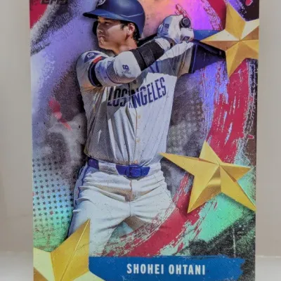 Topps Shohei Ohtani Los Angeles Dodgers trading card featuring a vibrant metallic foil star design.