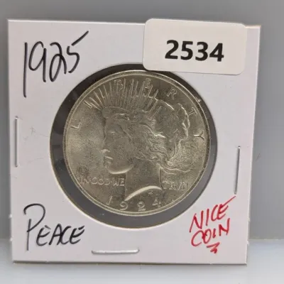 1924 Peace Silver Dollar encased in a cardboard coin holder labeled '1925 Peace' and 'Nice Coin'.