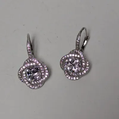 Pair of sterling silver or white gold drop earrings with round-cut center stones and pave diamond-style halos on lever-back ear wires.