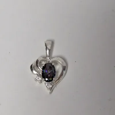 Silver heart-shaped pendant featuring a central oval mystic topaz gemstone framed by clear accent stones.