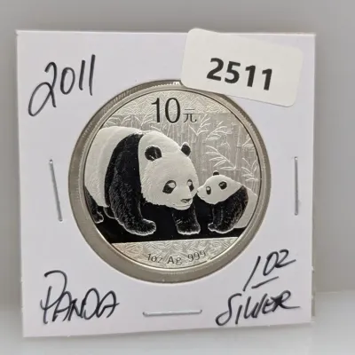 2011 Chinese Silver Panda 10 Yuan coin, featuring 1 oz .999 fine silver, preserved in a cardboard coin flip holder.