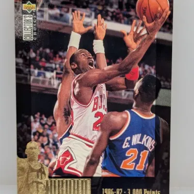 1997-98 Upper Deck Collector's Choice Michael Jordan 1986-87 3,000 Points basketball card in good condition with a gold foil logo...