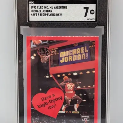 SGC-graded 7 NM copy of a 1991 Cleo Inc. Michael Jordan 'Have a high-flying day!' Valentine card, encased in a protective slab.