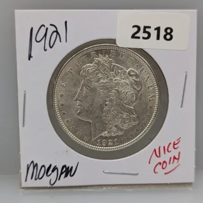 1921 Morgan silver dollar coin housed in a cardboard flip holder.