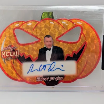 Leaf Metal Robert De Niro autographed die-cut pumpkin trading card housed in a protective case.