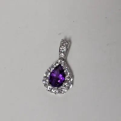 Pear-cut amethyst gemstone pendant surrounded by a halo of clear accent stones and a pave-set bail in a silver-tone metal setting.