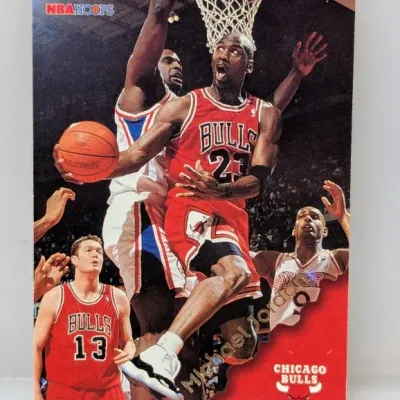 1996-97 NBA Hoops Michael Jordan #11 trading card featuring action shots in his Chicago Bulls uniform.