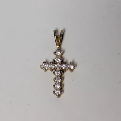 Yellow gold cross pendant set with clear round-cut stones.