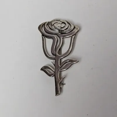 Vintage sterling silver rose brooch featuring an openwork floral motif.