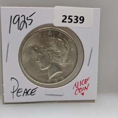 1925 United States Peace silver dollar coin mounted in a cardboard protective flip.
