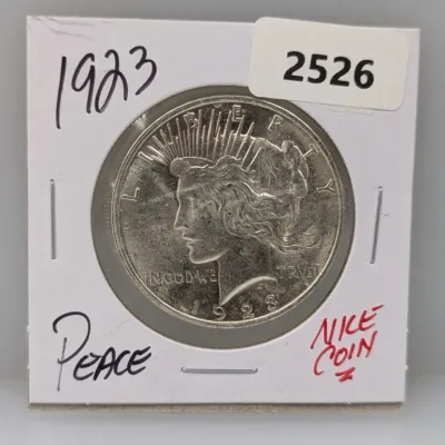 1923 United States Peace Silver Dollar coin presented in a protective paper flip.