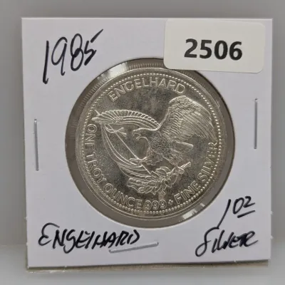 1985 Engelhard one troy ounce .999 fine silver round in a cardboard flip holder.