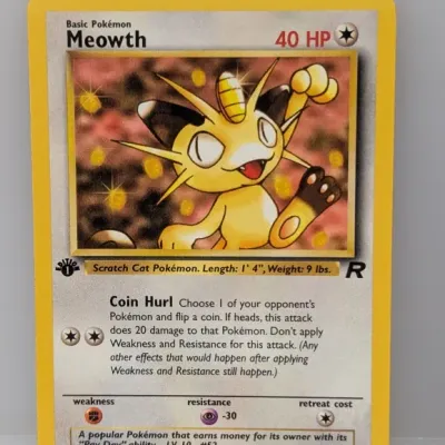 1st Edition Team Rocket Meowth Pokémon card, number 62/82, illustrated by Atsuko Nishida and released in 2000.