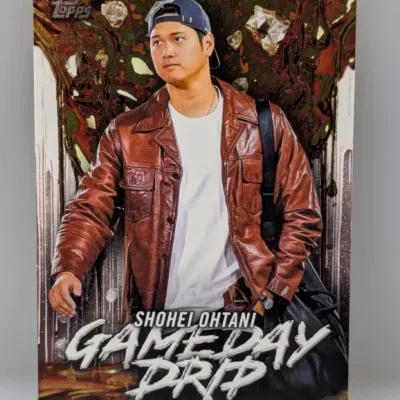 Topps Shohei Ohtani 'Gameday Drip' insert trading card, featuring Ohtani in casual street attire against a stylized foil...