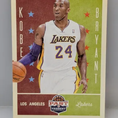 Panini Past & Present Kobe Bryant basketball trading card featuring him in a Los Angeles Lakers home jersey.