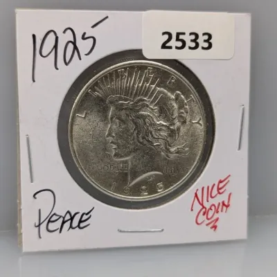 1925 Peace silver dollar coin in a protective cardboard flip holder.