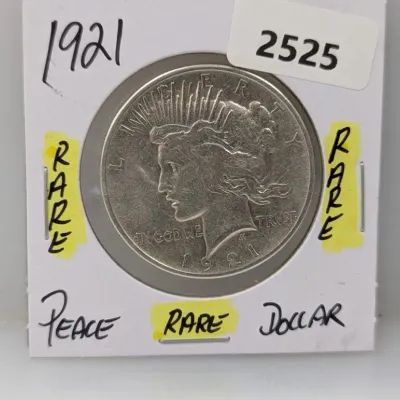 1921 Peace Silver Dollar high-relief key date coin in a protective cardboard flip.