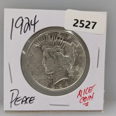 1924 Peace silver dollar housed in a cardboard 2x2 coin holder.