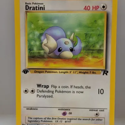 1st Edition Dratini #53/82 Pokémon trading card from the Team Rocket set, illustrated by Kagemaru Himeno and published by Wizards of the...