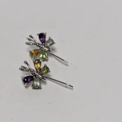 Pair of sterling silver dragonfly-shaped stud earrings featuring multicolored pear-cut gemstones including amethyst, citrine, and peridot.