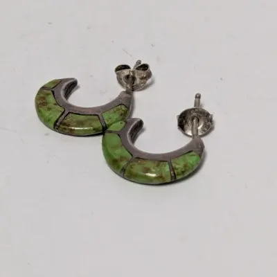 Pair of Southwestern-style sterling silver hoop earrings with inlaid green turquoise.