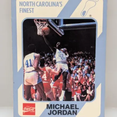 1985-86 Interlake Michael Jordan #1 collegiate basketball card featuring a photo of Jordan playing for the University of North Carolina...