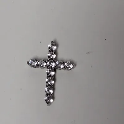 Silver-tone cross pendant inset with round faceted clear stones.