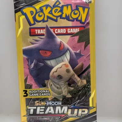 Sealed Pokémon Trading Card Game Sun & Moon Team Up booster pack featuring Gengar and Mimikyu artwork.