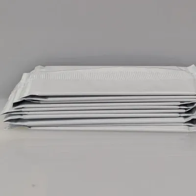 Stack of white padded bubble mailer envelopes in unused condition.