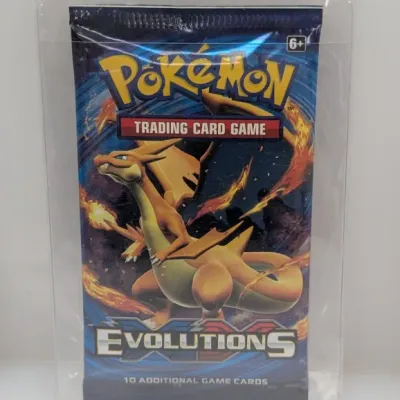 Sealed Pokémon XY Evolutions booster pack featuring Charizard artwork, encased in a clear protective sleeve.