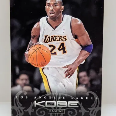 Panini Kobe Bryant Los Angeles Lakers trading card featuring a front image of Bryant handling a basketball in his white home jersey.