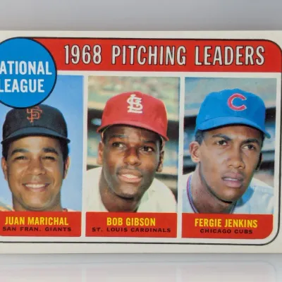 1969 Topps #12 National League Pitching Leaders baseball card featuring Juan Marichal, Bob Gibson, and Fergie Jenkins.