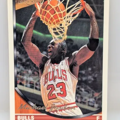 1993-94 Topps Gold Michael Jordan #23 basketball card featuring a two-handed dunk action photo.