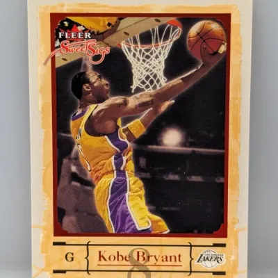 Kobe Bryant Fleer Sweet Sigs trading card featuring the Los Angeles Lakers star going for a layup, in good overall condition.