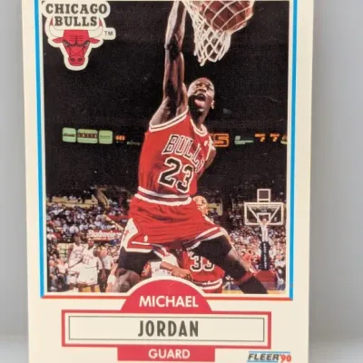 1990 Fleer Michael Jordan #26 basketball card in good condition, featuring a classic action shot of Jordan dunking.