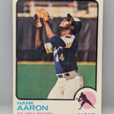 1973 Topps Hank Aaron baseball card (#100), featuring the Atlanta Braves first baseman in action with minor corner wear.