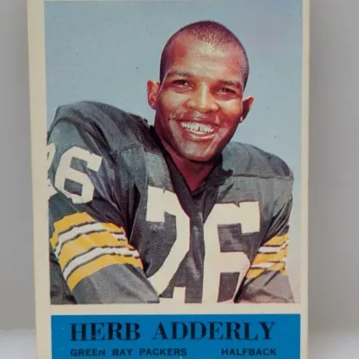 Vintage 1964 Philadelphia Gum Herb Adderley Green Bay Packers football card #73, featuring a color portrait of the hall of fame halfback.