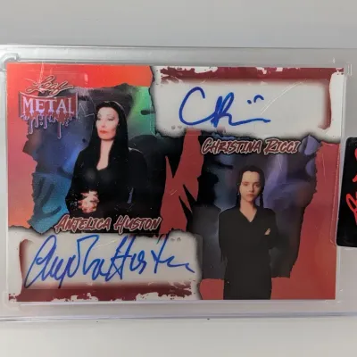Leaf Metal Pop Century dual autograph trading card featuring Anjelica Huston and Christina Ricci, enclosed in a protective magnetic case.