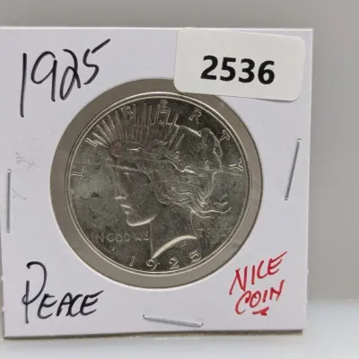 1925 Peace silver dollar coin presented in a cardboard flip holder.
